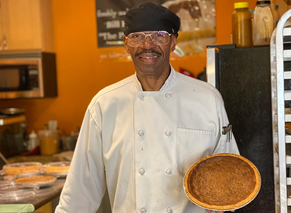 Baked From the Hart owner Bill Hart holding a sweet bean pie inside his business in Seattle, Washington.