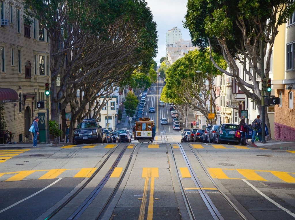 Tree-lined intersection with a streetcar in San Francisco.