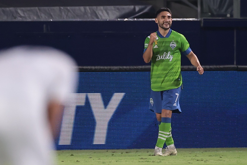 Seattle Sounders midfielder, Cristian Roldan pumps his fist with a smile.