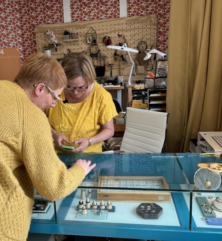 Sally interacts with a customer in her studio and retail shop.